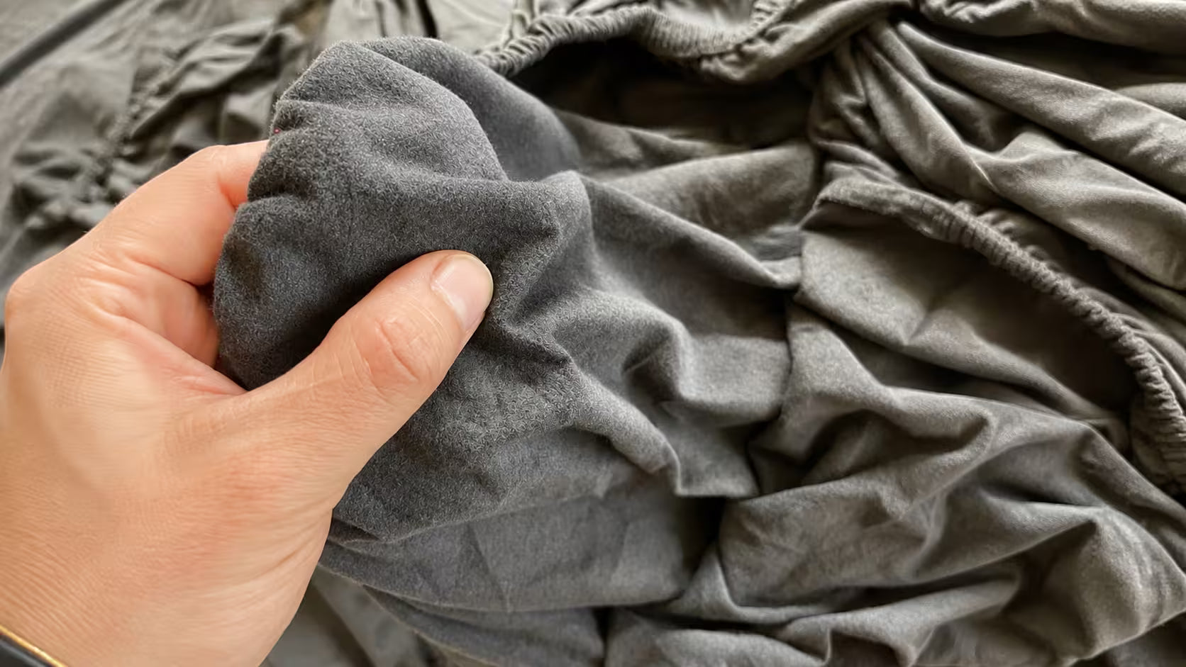 Satin car cover fabric with fleece lining next to a thick plush fleece car cover fabric