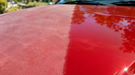 Sun faded chalky red car paint next to healthy glossy paint on the same panel